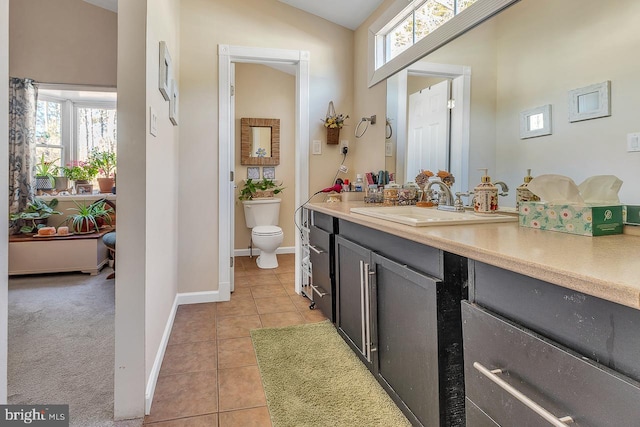 bathroom featuring tile patterned flooring, plenty of natural light, vanity, and toilet