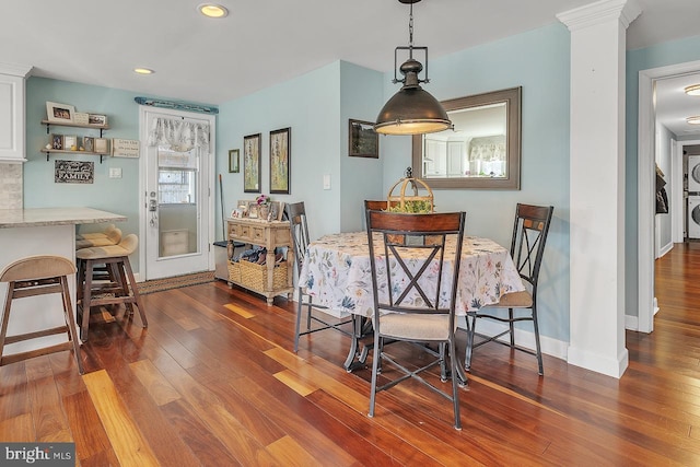 dining area with dark wood-style floors, recessed lighting, decorative columns, and baseboards