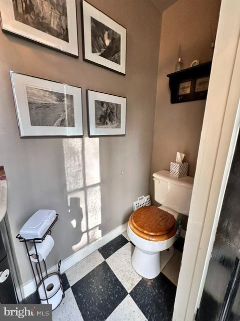 bathroom featuring baseboards, toilet, and tile patterned floors