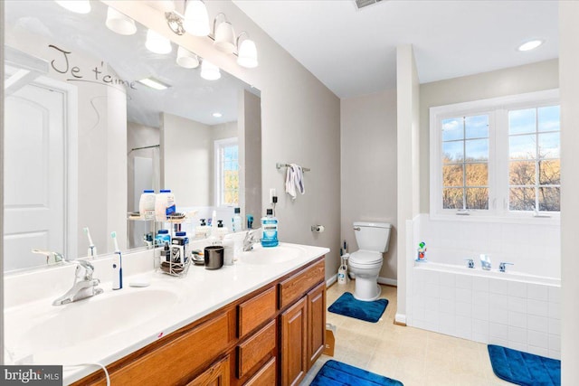 full bath with a garden tub, double vanity, a sink, and toilet