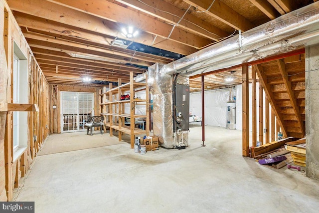 unfinished basement featuring water heater and heating unit