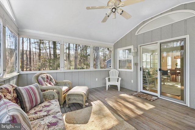 sunroom featuring lofted ceiling and a ceiling fan