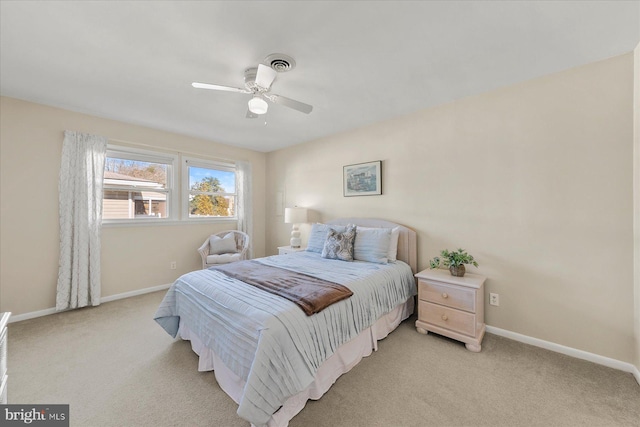 bedroom featuring baseboards, visible vents, and light colored carpet