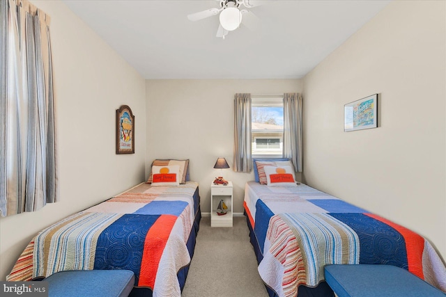 carpeted bedroom featuring a ceiling fan and baseboards