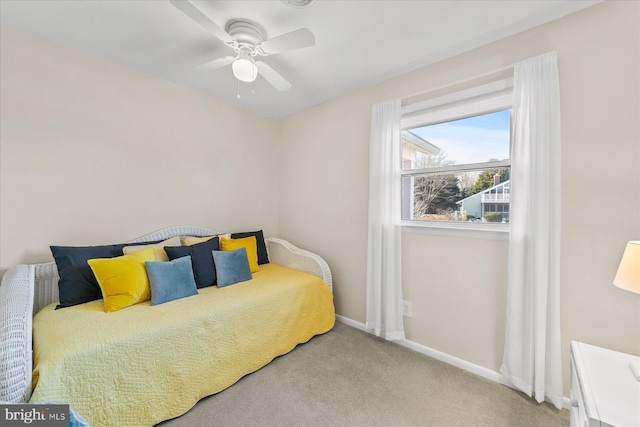 carpeted bedroom featuring ceiling fan and baseboards