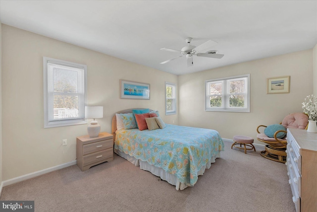 bedroom featuring light carpet, ceiling fan, and baseboards