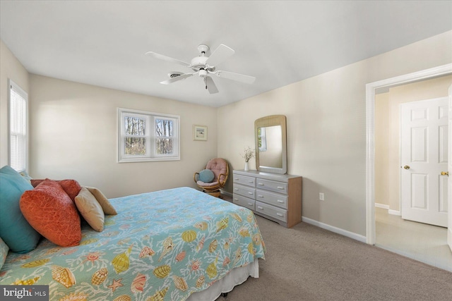 bedroom featuring ceiling fan, baseboards, and light colored carpet