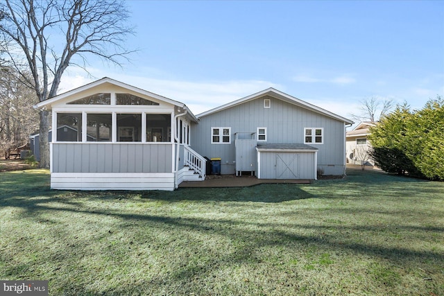 rear view of house featuring a sunroom and a lawn