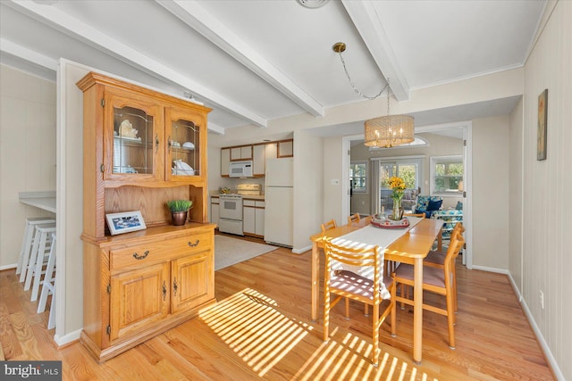 dining room featuring light wood-type flooring, a notable chandelier, beamed ceiling, and baseboards