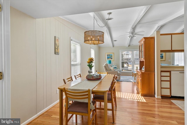 dining space with a ceiling fan, visible vents, beamed ceiling, and light wood finished floors