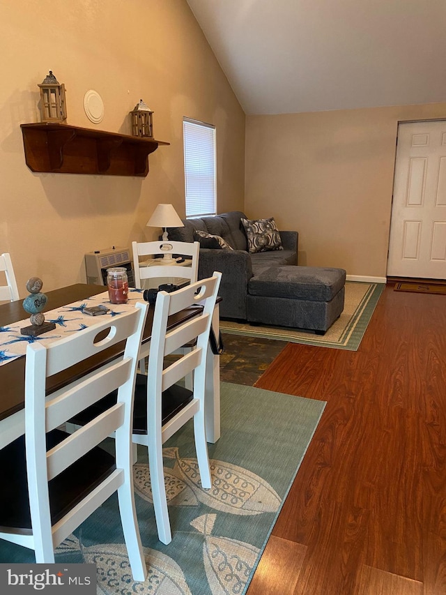 dining room featuring lofted ceiling, baseboards, and dark wood-type flooring