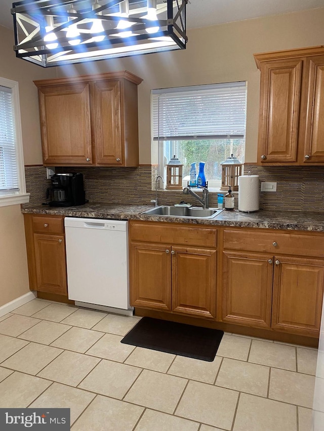 kitchen with a sink, brown cabinets, and dishwasher