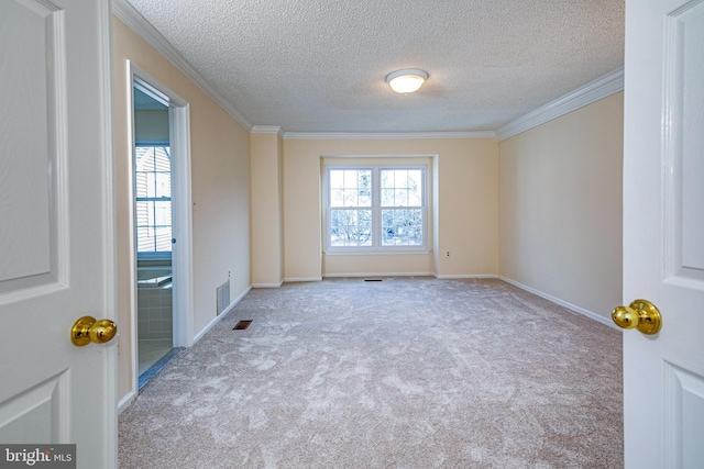 empty room featuring light colored carpet, crown molding, visible vents, and baseboards