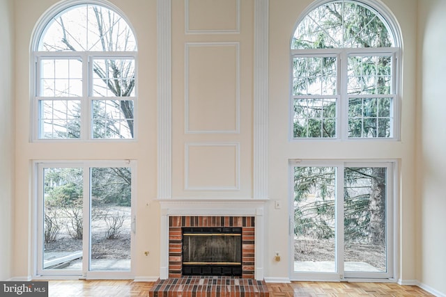 living room with a fireplace and a high ceiling