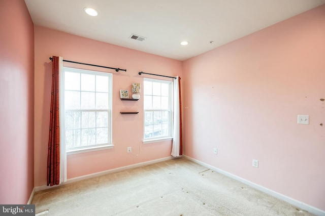 unfurnished room with light carpet, visible vents, recessed lighting, and baseboards