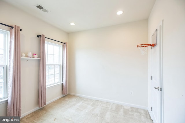 spare room featuring recessed lighting, visible vents, light carpet, and baseboards