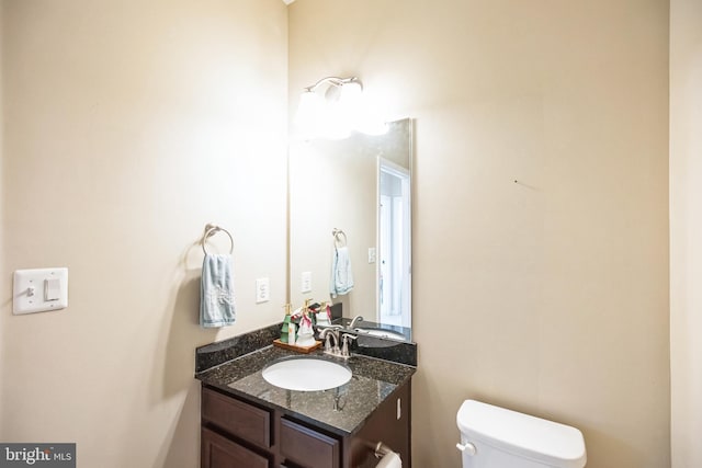 half bathroom with toilet and vanity
