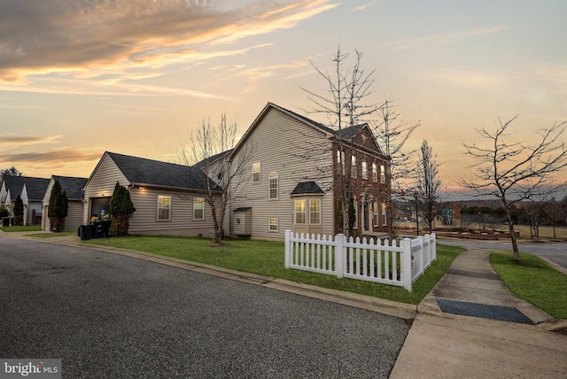 view of front of home featuring a fenced front yard and a lawn