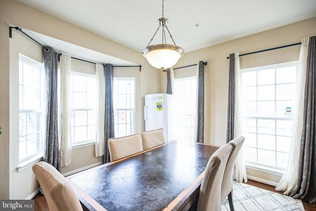 dining space featuring baseboards