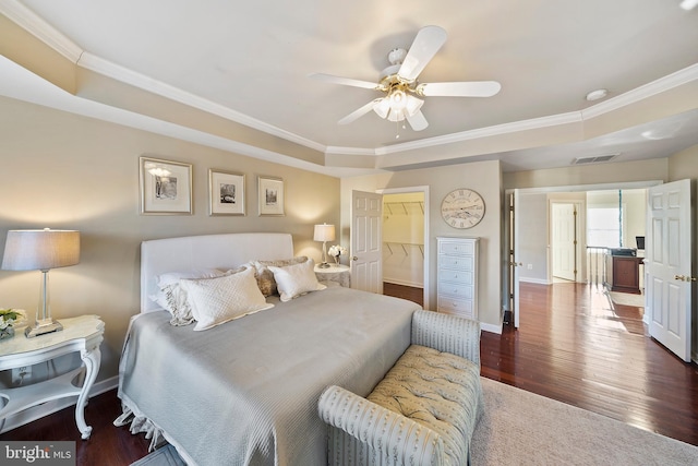 bedroom with baseboards, visible vents, a ceiling fan, wood finished floors, and crown molding