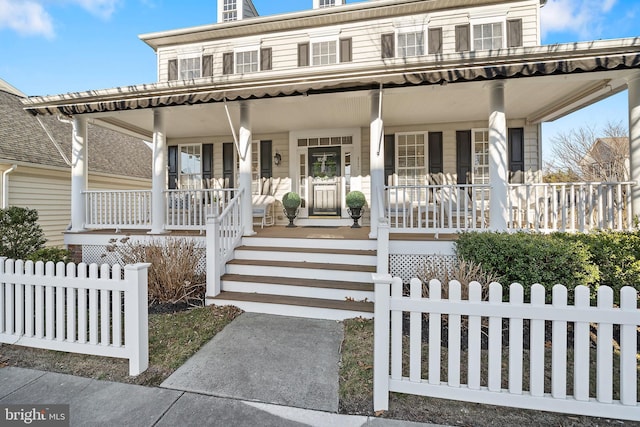 view of front of property featuring a fenced front yard and covered porch