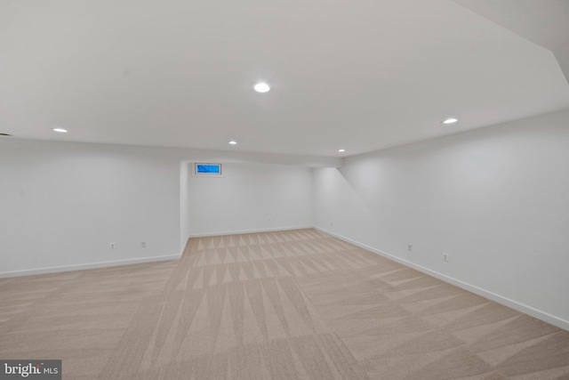 finished basement with baseboards, light colored carpet, and recessed lighting