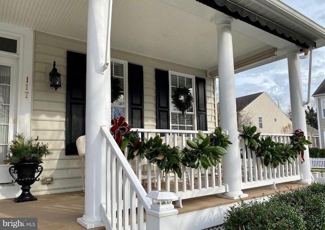 view of exterior entry with a porch