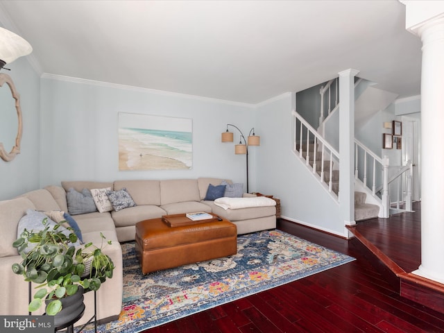 living area featuring stairs, ornamental molding, wood finished floors, and decorative columns