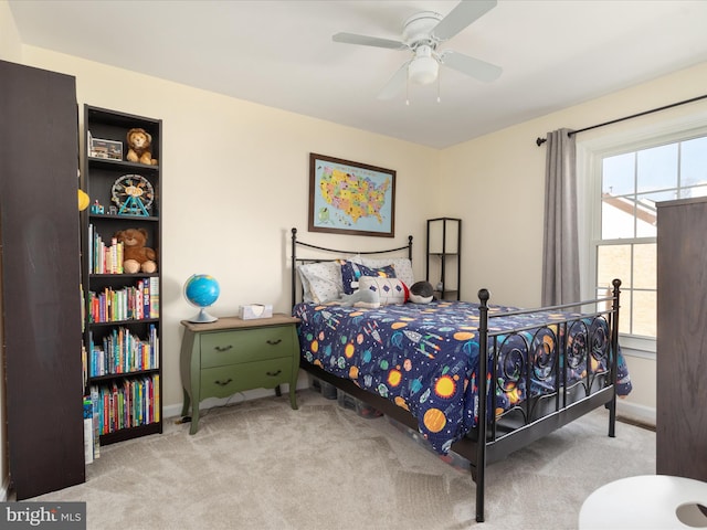 bedroom featuring ceiling fan, baseboards, and light colored carpet