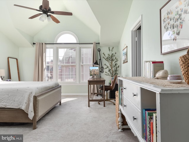 bedroom with vaulted ceiling, baseboards, and light colored carpet