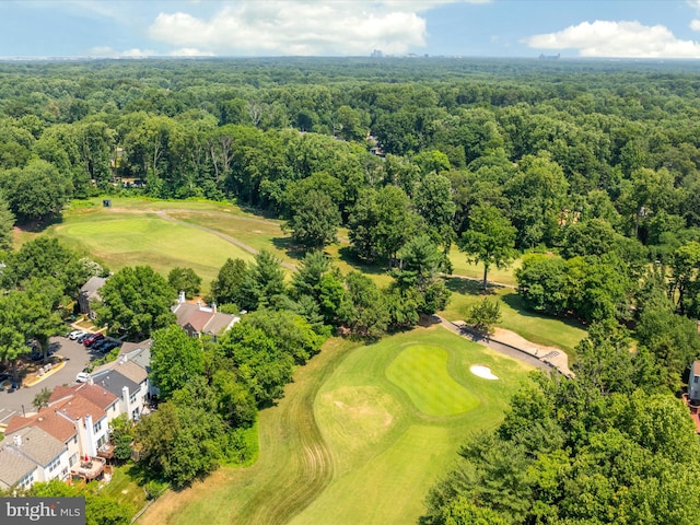 bird's eye view featuring a wooded view and golf course view