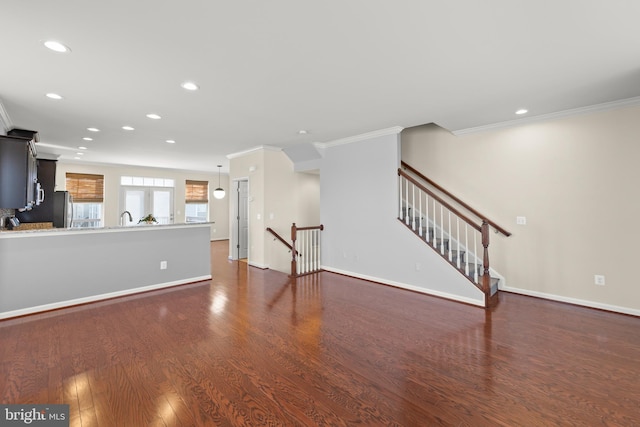 unfurnished living room featuring baseboards, dark wood finished floors, crown molding, and recessed lighting