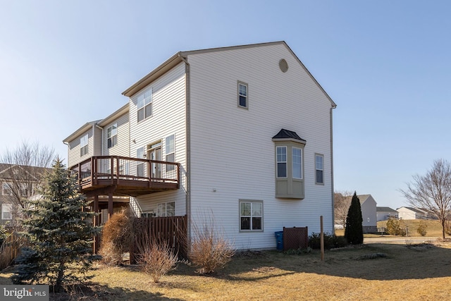 view of property exterior with a yard and a wooden deck