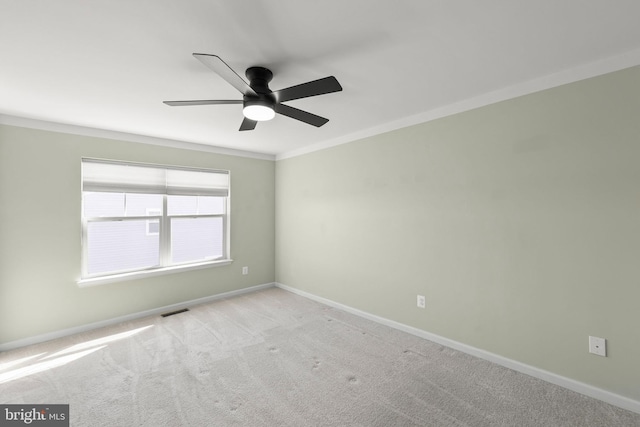 unfurnished room with baseboards, visible vents, crown molding, and light colored carpet