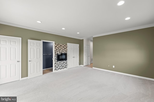 unfurnished bedroom with recessed lighting, light colored carpet, a fireplace, and baseboards