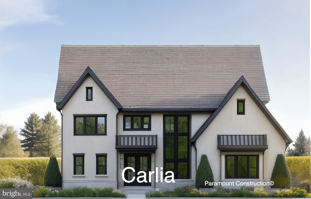 rear view of house featuring stucco siding