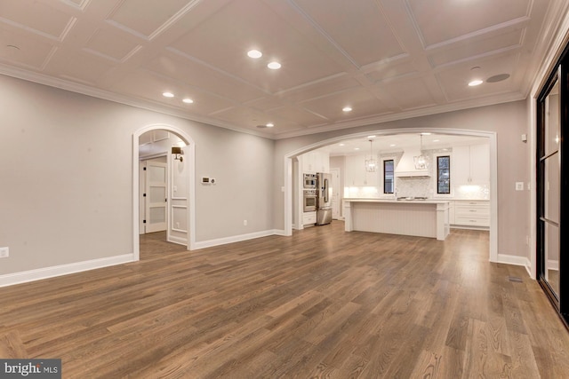 unfurnished living room with dark wood-style floors, baseboards, and arched walkways