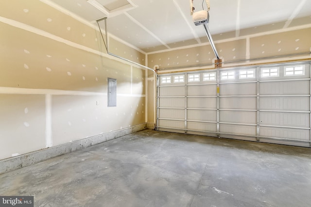 garage featuring electric panel and a garage door opener