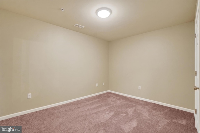 carpeted empty room with baseboards and visible vents