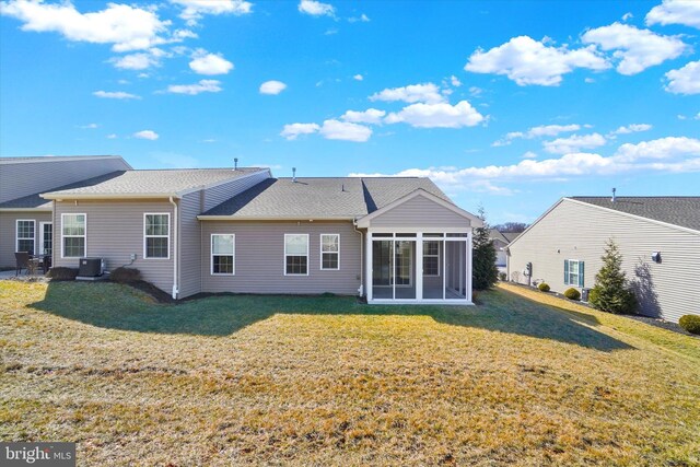 rear view of property with a yard, central AC, a sunroom, and roof with shingles