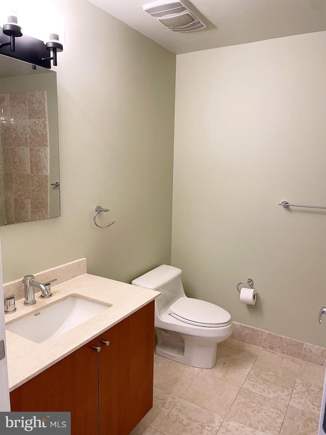 bathroom featuring toilet, visible vents, and vanity