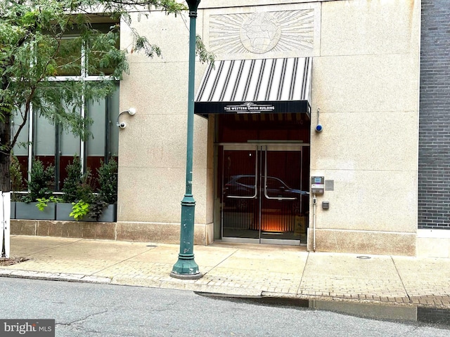 doorway to property with stucco siding