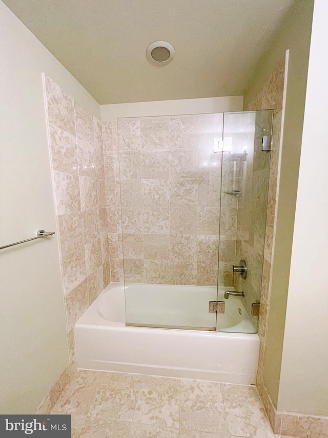 bathroom featuring enclosed tub / shower combo and baseboards