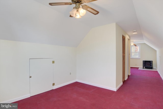 additional living space featuring carpet flooring, vaulted ceiling, baseboards, and ceiling fan