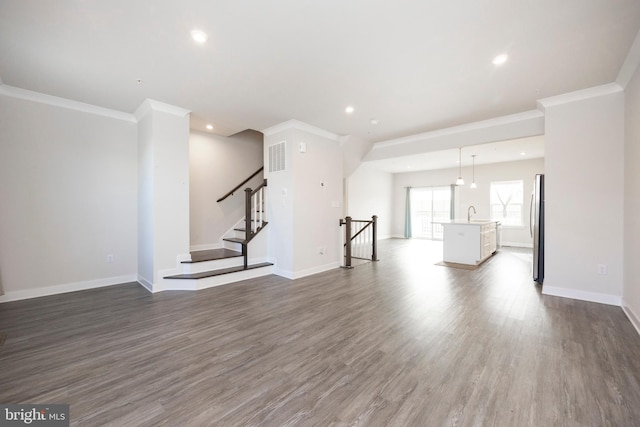 unfurnished living room featuring recessed lighting, baseboards, and wood finished floors