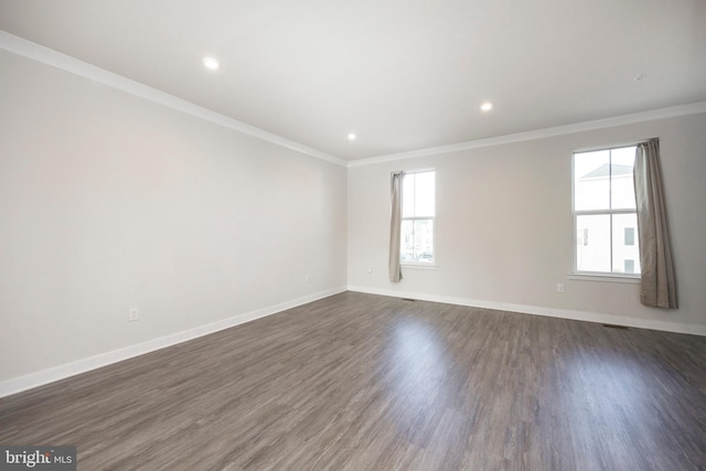 unfurnished room with ornamental molding, recessed lighting, dark wood finished floors, and baseboards