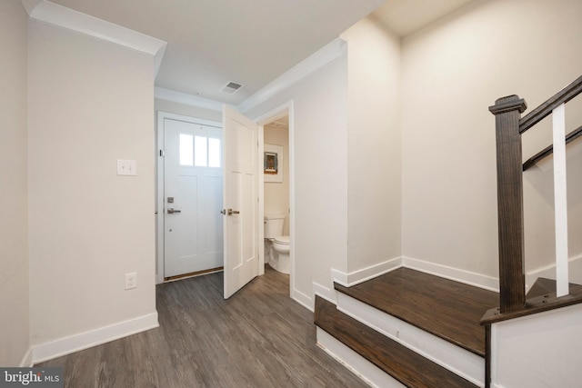 foyer entrance with dark wood-style flooring, visible vents, stairway, and baseboards