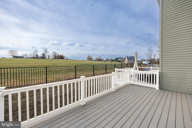 wooden deck with a yard and a rural view