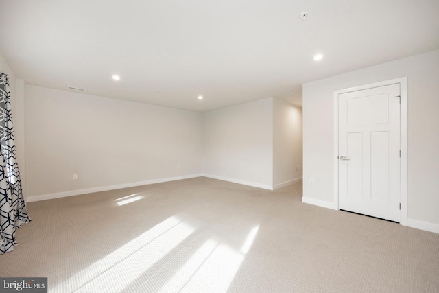 empty room with visible vents, baseboards, light colored carpet, and recessed lighting