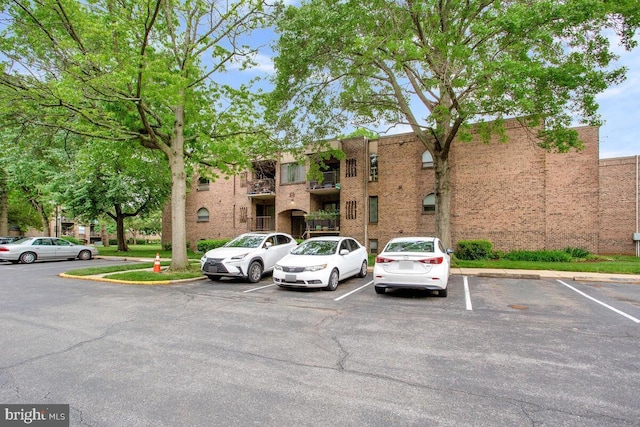 view of building exterior featuring uncovered parking